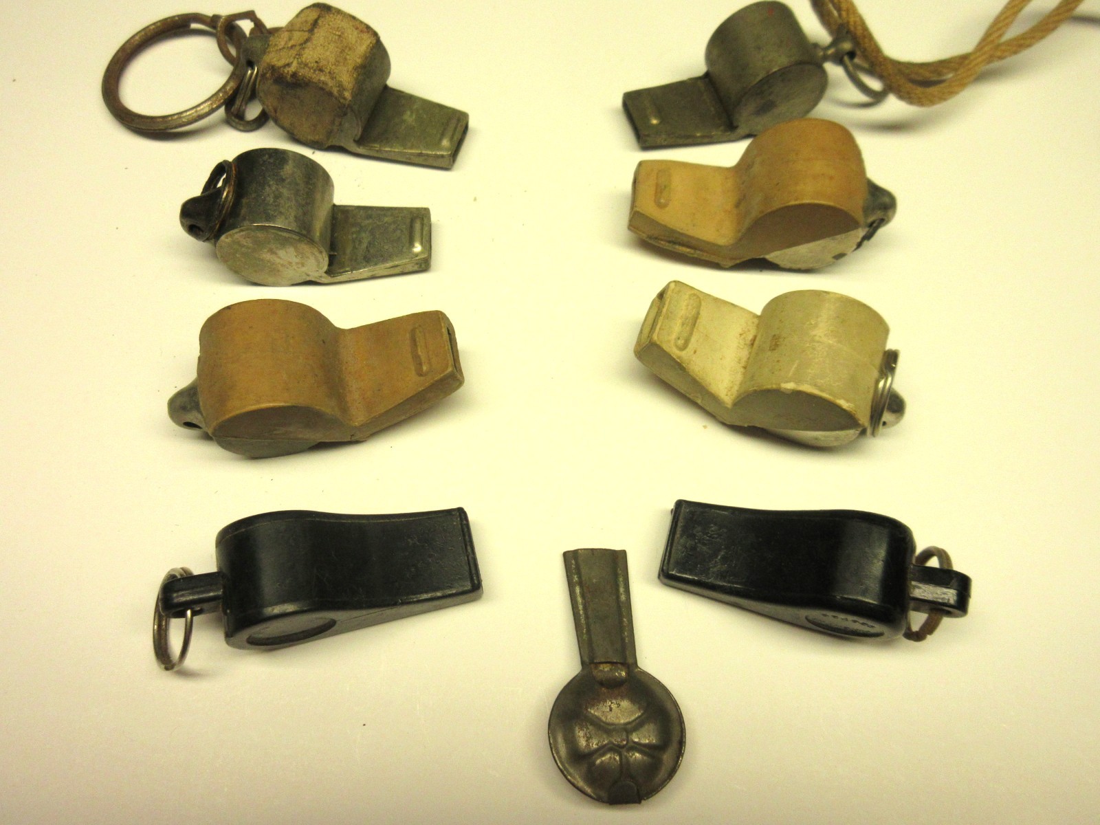 (9) Acme Thunderer Whistles. Small Metallic and plastic vintage whistles.