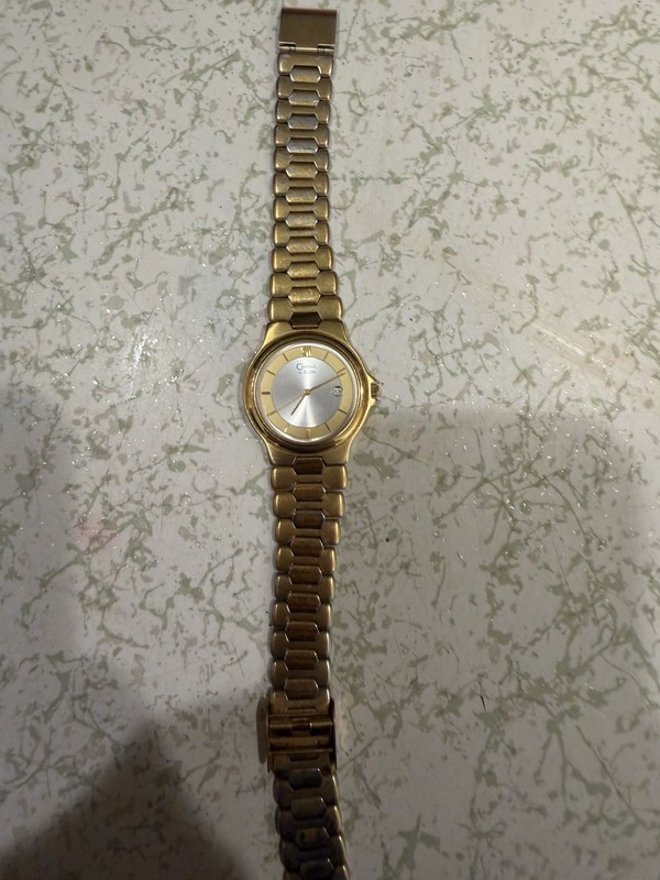 Caravelle by Bulova Quartz Gold Tone Bracelet Watch Silver Dial Date Roman