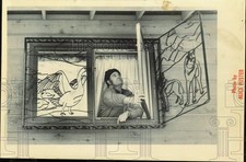 Press Photo Bill Mashburn opens window decorated with metal art security bars