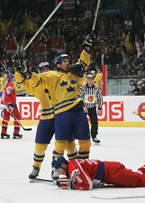 Jonathan Hedstrom hugs teammate Jonas Hoglund of Sweden afte- Ice Hockey Photo
