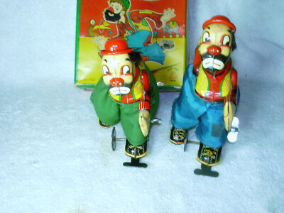 2 VINTAGE 1950s WIND UP CLOWNS ON ROLLER SKATES 1 IN ORIGINAL BOX