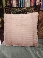 Pale pink plush pillow,horizontal lined.