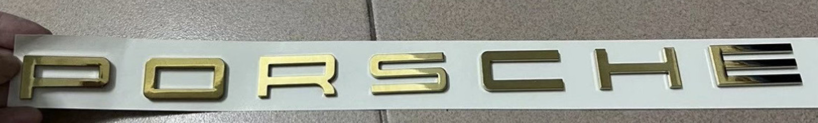  Customized  gold colored letter badge as shown in the figure
