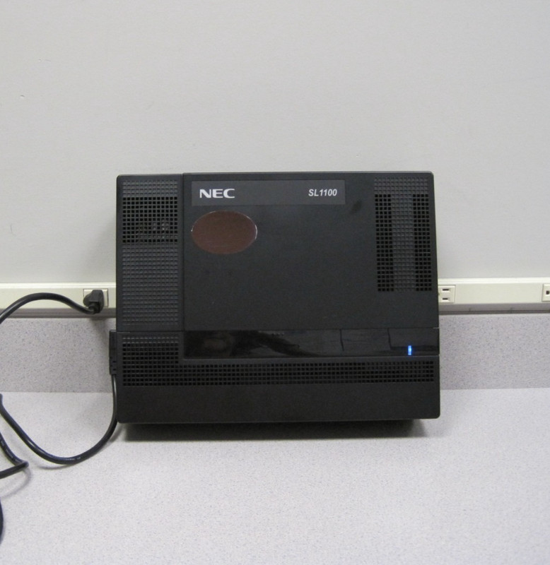 1 NEC SL 1000 IP4NA Cabinet  9 NEC IP4WW-24TXH-B Telephones