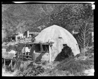Small adobe dome showing larger adobe structures in background Cal - Old Photo