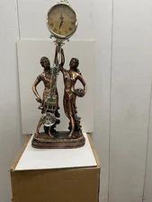 swinging statue clock with musician