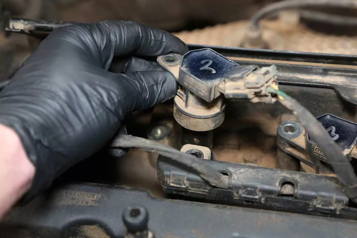 A mechanic pulling the #2 coil.