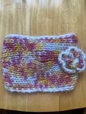 multicolored knit headband with a textured flower accent