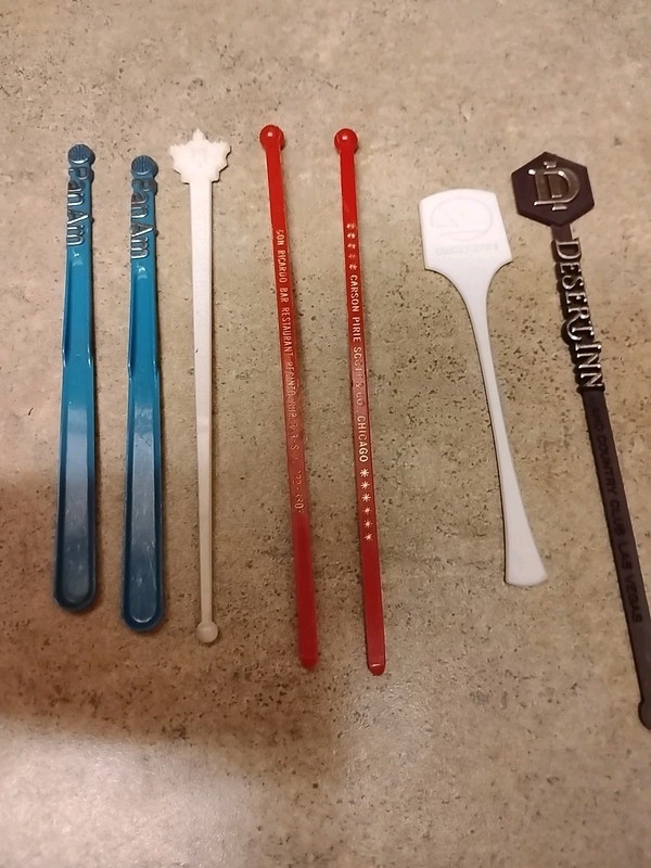 A Mix Of 7 Airline & Hotel Swizzle Sticks