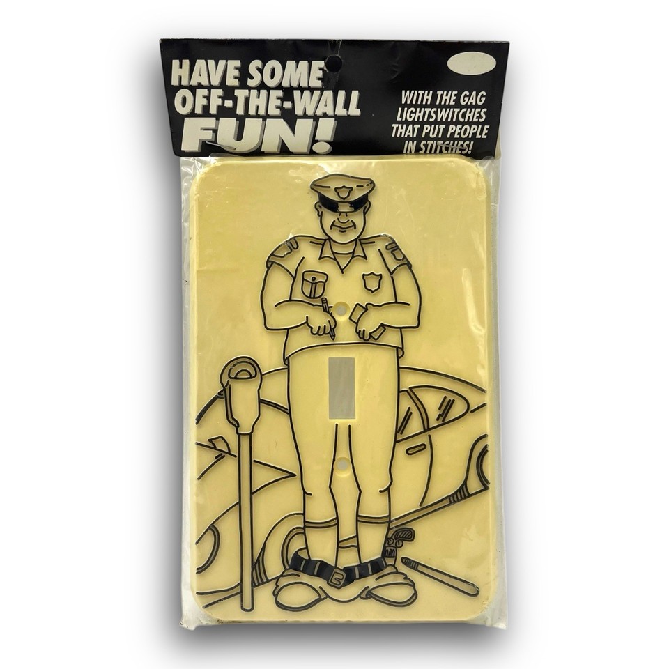 A deadpan 1976 novelty light switch plate shaped like a cop — the kind of hyper-specific kitsch that makes a room instantly more interesting.