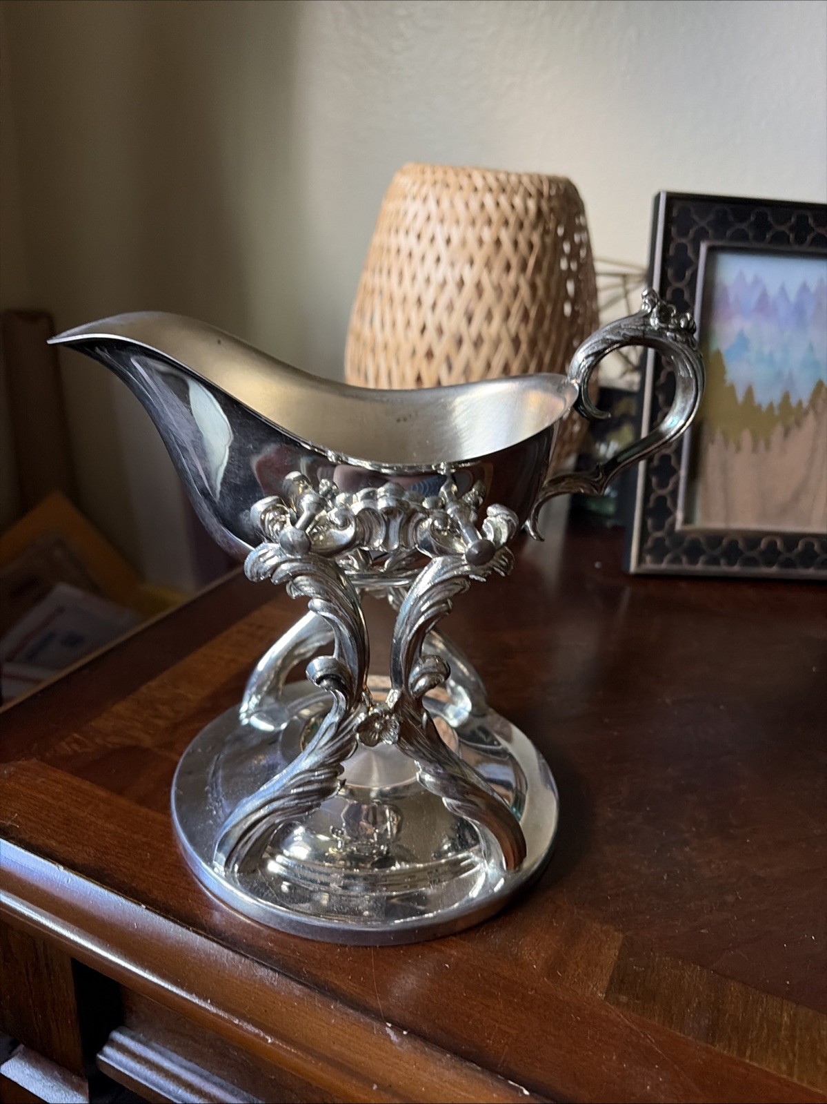 EB Rogers silver plate gravy boat on a candle warmer cradle stand.