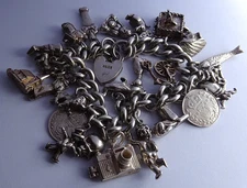 Vintage 100.2g solid silver charm bracelet,many curious silver charms inc moving