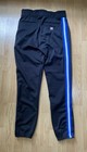 Black Wilson RMB A4409 men’s baseball pants with blue and white vertical stripes on the back, made in USA.