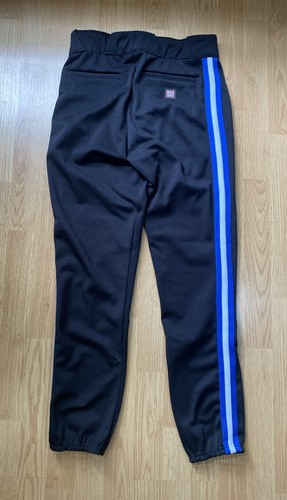 Black Wilson RMB A4409 men’s baseball pants with blue and white vertical stripes on the back, made in USA.