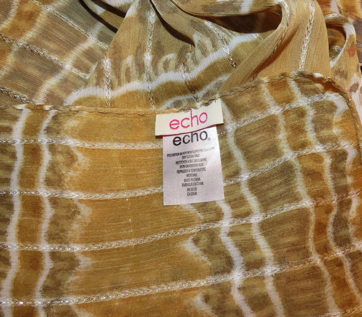 Echo oblong scarf; abstract; tan white black; metallic accents; poly; 72x20 in.