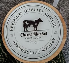 Round wooden cheese board with knives