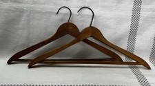 vintage set of wooden clothes hanger with a dark brown finish and a metal hook.