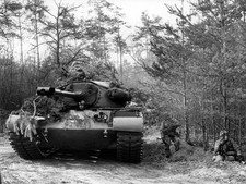 Soldiers of US army next to a camouflaged Patton tank during an ex- Old Photo