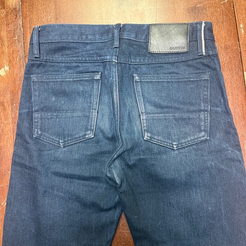 Back view of Gustin jeans men 30x29 indigo raw selvedge denim with two pockets and black leather patch on waistband.