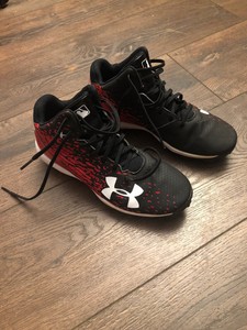 red and black under armour baseball cleats