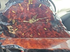 handcrafted table clock made from a natural, live-edge wood slab, likely...