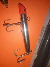 silver and blaze orange tubular metal jig