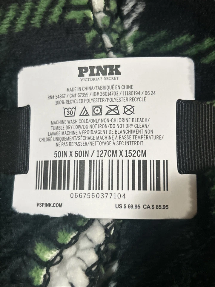 Acogedora manta de felpa rosa verde con perros blancos y logotipo Foto 2 de 3