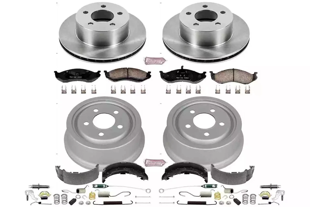 A complete set of Powerstop front disc (top) and rear drum brakes (bottom) for the 1991-1999 Jeep Cherokee and Wrangler, with springs and various parts, displayed on a white background.