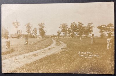 Burgs Park Shell Lake Wisconsin RPPC Town View in background