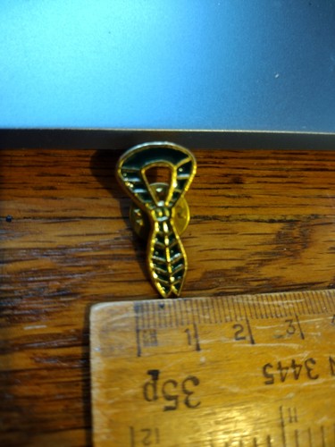 Dark green necker pin badge, used
