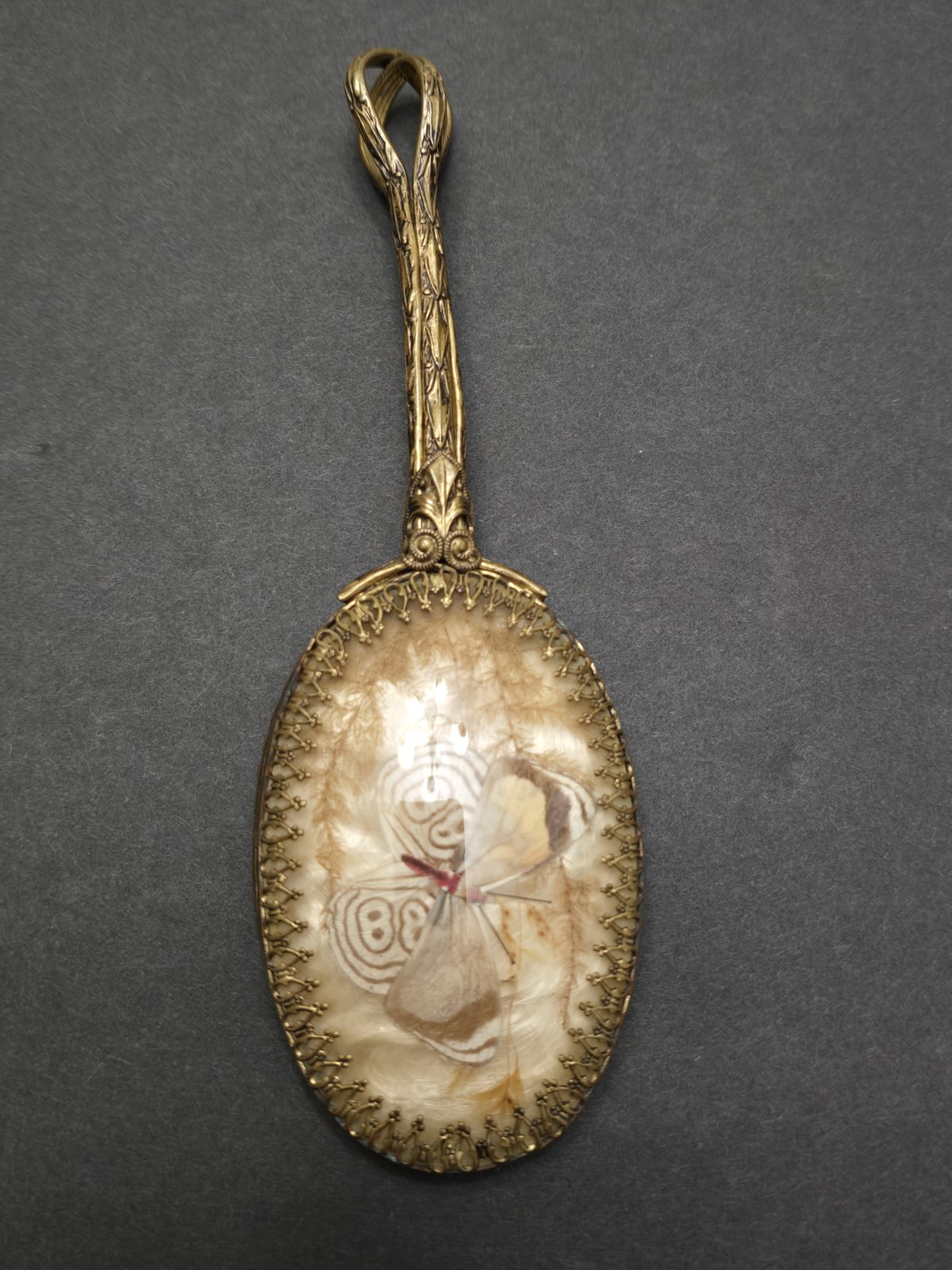 Antique Victorian hand mirror with a butterfly-shaped back set with woven human hair mourning art
