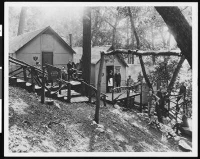 People outside a line of mountain cabins 1930 California Old Photo