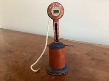 Antique Hullco Toys tin mechanical gas pump with U.S. Gasoline branding 1920s