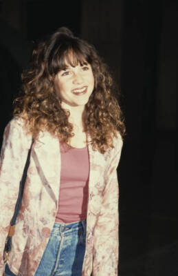 Olivia Burnette wearing a pink floral pattern jacket over a pi- 1992