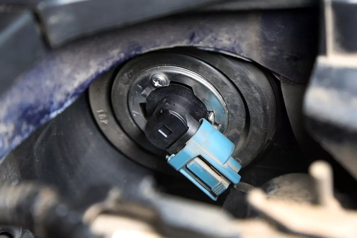 Unlocking and removing a headlight bulb to easily replace it.