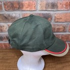 Green vintage Dairyland seed hat with red and white logo and red stripe, displayed on brown mannequin head.