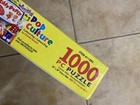 Yellow White Mountain POP CULTURE box with cartoon characters, large number 1000, and text “USA Made.”