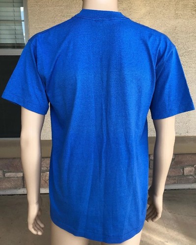 Royal blue short-sleeve shirt with white POW MIA Never Forgotten stamp and USA flag on back, worn on mannequin.
