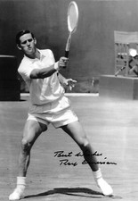 roy emerson returns the ball during the match on grass signed 12x8 photo