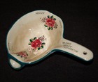 White ceramic gravy separator with red and green floral pattern, teal rim, and text “NO.DRIP GRAVY SEPARATOR” in white.
