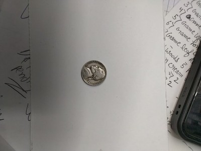  trade dollar with unknown date due to a drilled hole.