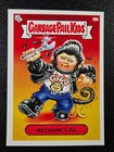 Greaser Greg comic card from Garbage Pail Kids, blue shirt, black hair, holding wrench, yellow-red circle background.