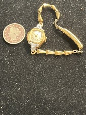 Woman Bulova 10 Karat Gold Filled Diamond Accent Watch