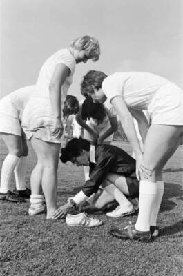 Coach Pat Dunn checks for a possible injury to Jill Stockley as Ma- Old Photo