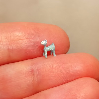Tiny and irridescent blue giraffe figurine. Micro miniature.