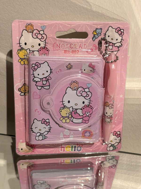 Hello kitty mini pink notebook with pen keychain.