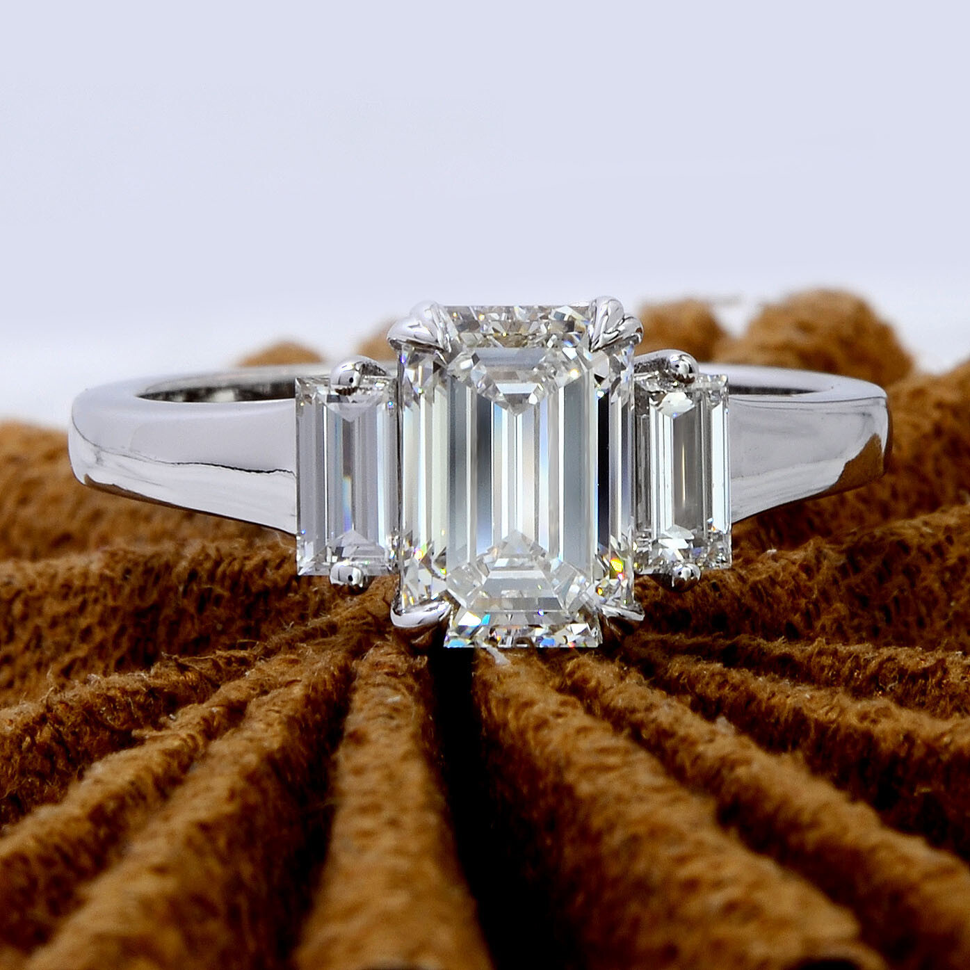 2.03 CT Emerald Cut Colorless Moissanite Bezel Set Three Stone