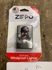 Zippo Lighter 3 skulls Made in U.S.A. box with black/silver design, red/white label, and orange cap.