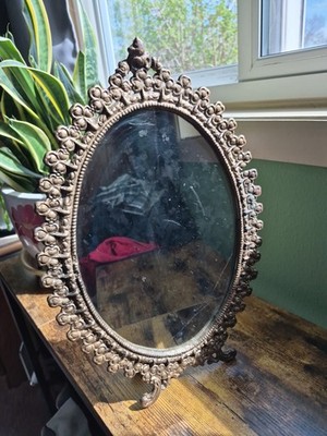 Vintage cast metal standing mirror 15'' tall, clover design, mirror has flaw