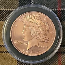 1 oz .999 copper round peace dollar.